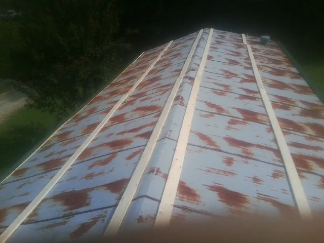 Rusted metal roof panels with new wood purlins before replacement — Storm Damage Roof Repair in Santee by Roofing Brothers